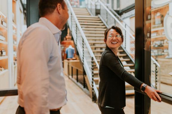 Employee holding door for another