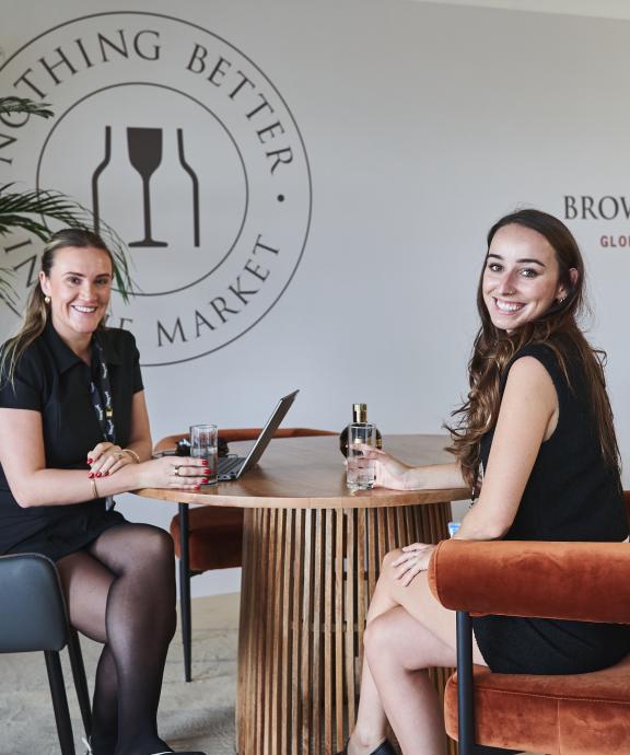 Employees sitting at table with cocktails and zero-proof cocktails