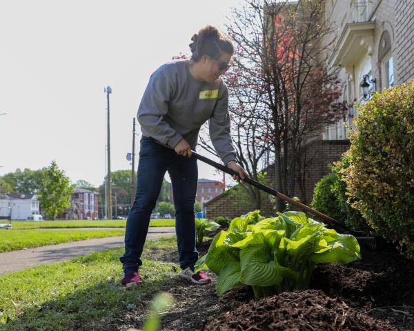 Employees doing yard work for community neighbor