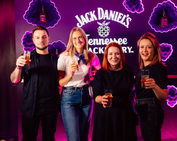 Employees toasting with a Jack Daniel's Blackberry banner in background